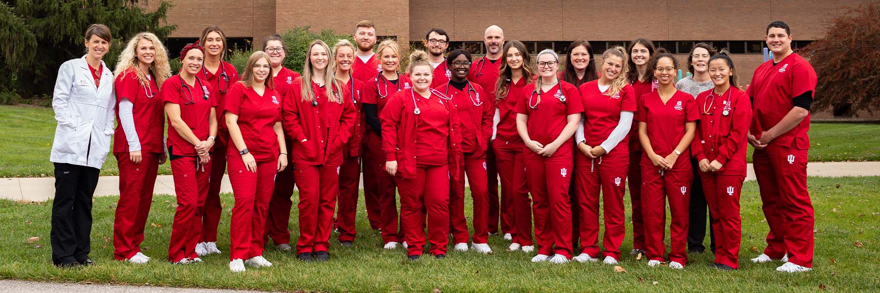 Group of IUFW students and instructors stand outside an IU Fort Wayne building