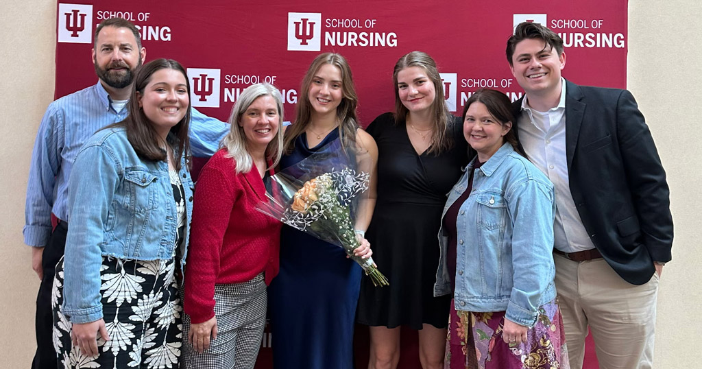 Abbey Vastag (center) poses with family in front of an IU School of Nursing banner during the 2026 Spring Recognition Program.