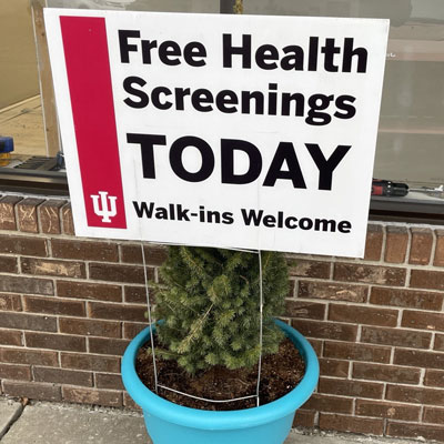 A sign outside of a regional clinic experience reads "Free Health Screenings TODAY. Walk-ins Welcome."
