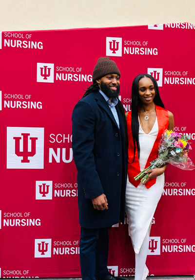 A December 2025 graduate poses for a photo during the IU School of Nursing in Indianapolis winter recognition ceremony.