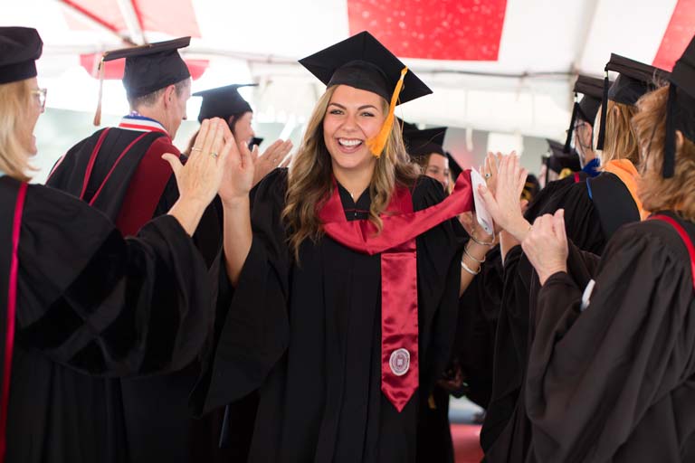Graduate giving high fives