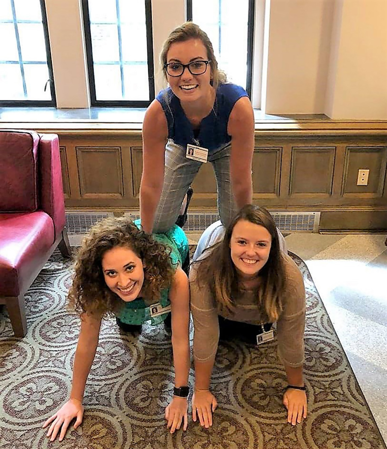 Students forming a cheerleading pyramid